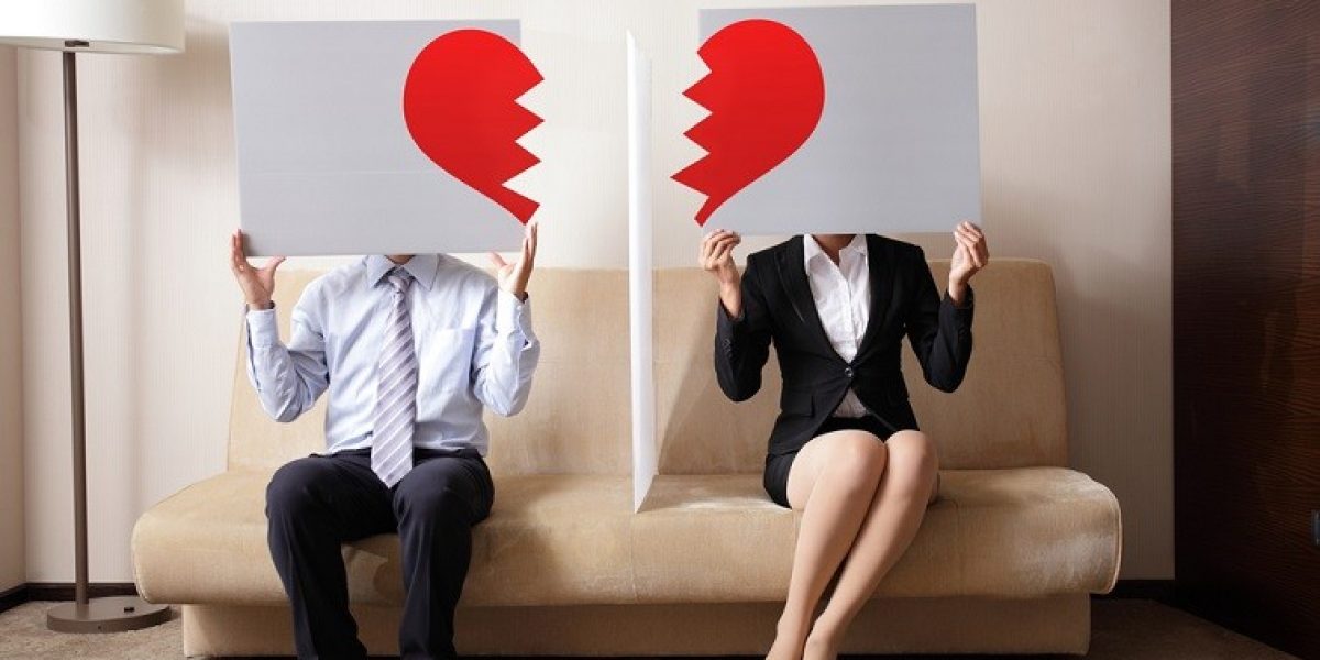 Divorce - Sad young couple holding billboard sign with break love heart, concept for divorce